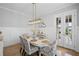 Charming dining room with modern light fixture, hardwood floors, and doors to outdoor patio at 2003 Haley Walk, Woodstock, GA 30188