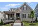 Charming home featuring brick and stone accents, a cozy front porch, and a well-manicured lawn at 2003 Haley Walk, Woodstock, GA 30188