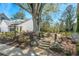 Landscaped front yard with mature trees and natural stone features, enhancing curb appeal at 2003 Haley Walk, Woodstock, GA 30188
