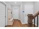 Hallway features hardwood flooring, a coat rack with bench, and white doors at 2003 Haley Walk, Woodstock, GA 30188