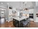 A gourmet kitchen featuring an oversized island with seating, modern appliances, and pendant lighting at 2003 Haley Walk, Woodstock, GA 30188