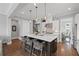 Open-concept kitchen with large island, bar stool seating, and stainless steel appliances, perfect for entertaining at 2003 Haley Walk, Woodstock, GA 30188