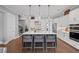 Bright kitchen features a large island with seating, stainless appliances, and pendant lighting at 2003 Haley Walk, Woodstock, GA 30188