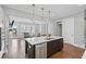 Modern kitchen with stainless steel appliances, a central island, and an open layout connecting to living spaces at 2003 Haley Walk, Woodstock, GA 30188