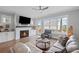 Cozy living room features a fireplace, recessed lighting, and views to the backyard at 2003 Haley Walk, Woodstock, GA 30188