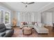 Well-lit living room with stylish decor, hardwood floors, and large windows at 2003 Haley Walk, Woodstock, GA 30188