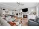 Open-concept living room featuring a fireplace, modern finishes, and seamless kitchen integration at 2003 Haley Walk, Woodstock, GA 30188