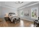 Tranquil bedroom featuring tray ceilings, natural light, and hardwood flooring at 2003 Haley Walk, Woodstock, GA 30188