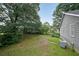 A grassy backyard with a view of mature trees offers a peaceful outdoor space adjacent to the house at 251 Lambeth Dr, Hiram, GA 30141