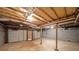 Spacious unfinished basement featuring exposed ceiling, concrete floor and walls, and garage door access at 251 Lambeth Dr, Hiram, GA 30141