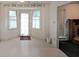 Bright breakfast nook featuring large windows with white curtains and a door to the backyard at 251 Lambeth Dr, Hiram, GA 30141