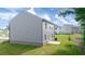 Large, well-maintained backyard with green grass and a view of the home's exterior at 45 Vermillion Trl, Covington, GA 30016