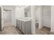 Another angle of the bright bathroom, highlighting double sinks and separate toilet area at 45 Vermillion Trl, Covington, GA 30016