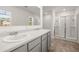 Bright bathroom featuring double sink vanity and glass-enclosed shower for spa-like experience at 45 Vermillion Trl, Covington, GA 30016
