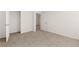 Bedroom with neutral walls, carpet, closet, and white doors at 45 Vermillion Trl, Covington, GA 30016