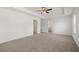 Spacious bedroom with neutral carpet and ceiling fan, offering a tranquil retreat at 45 Vermillion Trl, Covington, GA 30016