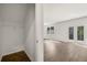View of an open coat closet area with wood floors, next to a living area with outside access at 45 Vermillion Trl, Covington, GA 30016