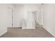Upstairs hallway with neutral carpet and white walls, leading to multiple bedrooms at 45 Vermillion Trl, Covington, GA 30016