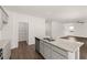 Kitchen featuring granite countertops, gray cabinetry, stainless appliances, and walk-in pantry access at 45 Vermillion Trl, Covington, GA 30016