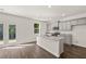 Modern kitchen features gray cabinets, granite countertops, stainless steel appliances, and a center island at 45 Vermillion Trl, Covington, GA 30016