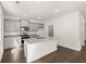Well-lit kitchen with gray cabinets, granite countertops, island with sink, and stainless steel appliances at 45 Vermillion Trl, Covington, GA 30016