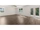 Living room with wood flooring, ceiling fan and French doors to the backyard at 45 Vermillion Trl, Covington, GA 30016