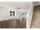 Bright living space with wood flooring, and views of the backyard and staircase at 45 Vermillion Trl, Covington, GA 30016