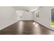 Spacious living area with dark wood flooring, ceiling fan, and lots of natural light at 45 Vermillion Trl, Covington, GA 30016