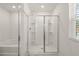 Luxurious glass-enclosed shower and soaking tub offers the ultimate relaxation in this bathroom at 45 Vermillion Trl, Covington, GA 30016