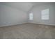 Bright and airy bedroom with vaulted ceiling, neutral carpet, and two large windows at 48 Beaver Pt, Villa Rica, GA 30180