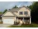Charming two-story home with neutral siding, stone accents, and an attached two-car garage at 48 Beaver Pt, Villa Rica, GA 30180