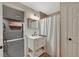 Cozy bathroom featuring a shower with a white curtain and vanity with drawers, along with an adjacent workout area at 6009 Castleton Mnr, Cumming, GA 30041