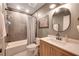 Modern bathroom with a shower-tub combination, vanity with sink, and neutral wall tiles at 6009 Castleton Mnr, Cumming, GA 30041