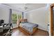 Bedroom with hardwood floors, neutral walls, a window with curtains, and a wooden bed frame at 6009 Castleton Mnr, Cumming, GA 30041