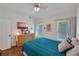 Bright bedroom with a large bed, hardwood floors, a dresser, and two windows with blinds at 6009 Castleton Mnr, Cumming, GA 30041