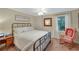This cozy bedroom features a bed, a window, and vintage decor accents at 6009 Castleton Mnr, Cumming, GA 30041