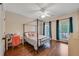 Bedroom featuring hardwood floors, a four-poster bed, neutral walls, and a door to the balcony at 6009 Castleton Mnr, Cumming, GA 30041