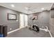 A bonus room with gym equipment and a neutral color scheme offers flexible space at 6009 Castleton Mnr, Cumming, GA 30041