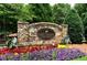 Stone entrance sign to the Golf Village at Windermere, with colorful flower beds at 6009 Castleton Mnr, Cumming, GA 30041