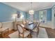 Formal dining room featuring wainscoting, hardwood floors, and elegant lighting for sophisticated gatherings at 6009 Castleton Mnr, Cumming, GA 30041