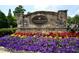 Stone entrance to the Southgate Village community, enhanced by colorful flowerbeds at 6009 Castleton Mnr, Cumming, GA 30041