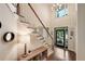 Bright foyer with a staircase, hardwood floors, and a front door with decorative glass panes at 6009 Castleton Mnr, Cumming, GA 30041