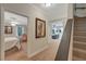 Hallway with stairway and views into the bedroom and living room creating an open and inviting atmosphere at 6009 Castleton Mnr, Cumming, GA 30041