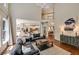 Spacious living room boasts hardwood floors, high ceilings, and seamless flow into the kitchen at 6009 Castleton Mnr, Cumming, GA 30041