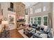 Bright living room featuring a stone fireplace, large windows, and comfortable seating for a relaxing atmosphere at 6009 Castleton Mnr, Cumming, GA 30041