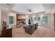 A bright living room features a stone fireplace with a TV, recessed lights, and outdoor access at 6009 Castleton Mnr, Cumming, GA 30041