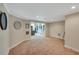A large living room with neutral carpet provides ample space for entertaining and relaxation at 6009 Castleton Mnr, Cumming, GA 30041