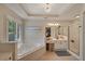 This large ensuite bath features a soaking tub, a shower, and a vanity with excellent lighting at 6009 Castleton Mnr, Cumming, GA 30041