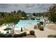 Resort-style community pool with waterslide, lounge chairs, and lush landscaping at 6009 Castleton Mnr, Cumming, GA 30041