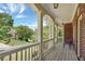 A covered front porch with stately columns provides outdoor seating and nice views at 6009 Castleton Mnr, Cumming, GA 30041